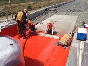 Workers install a Bridge Preservation™ Articulus Expansion Joint on the 1st Creek Bridge